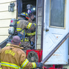 TRIBUNE PHOTOS
Fairmont Fire Department responded with mutual aid to Truman Saturday morning to assist battling a house fire at 533 E. First St. N. Two Fairmont firefighters emerged from the charred rear door of the home.
