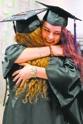 TRIBUNE PHOTOS
Class of 2023 Salutatorian Gracie Zaharia, right, gets a post-graduation hug from classmate and fellow senior Kayla Graplar.